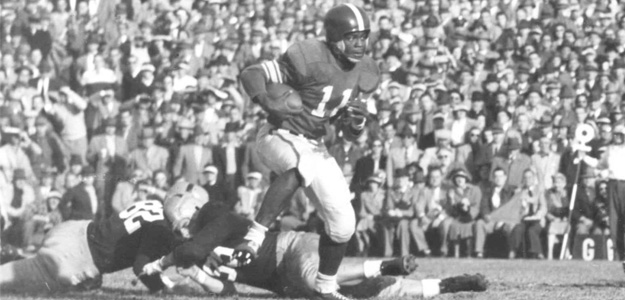 Michigan State's Jim Ellis returning the ball against Notre Dame in a 1951 football game