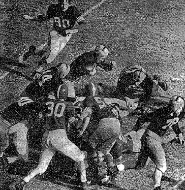Notre Dame carrying against Michigan State in a 1952 football game